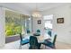 Bright dining area featuring a modern chandelier and views of the backyard at 14921 Barrows Bluff Ter, Bradenton, FL 34212