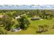 Expansive green property with a covered picnic area, sandy beach, and recreational equipment on a sunny day at 14921 Barrows Bluff Ter, Bradenton, FL 34212