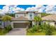 Charming two-story home featuring a well-manicured lawn and a beautiful, attached two car garage at 14921 Barrows Bluff Ter, Bradenton, FL 34212