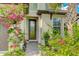 Charming front door entrance with brick walkway and beautifully landscaped garden featuring colorful flowering plants at 14921 Barrows Bluff Ter, Bradenton, FL 34212