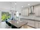 Spacious kitchen with stainless steel appliances, large island, and an adjacent dining area at 14921 Barrows Bluff Ter, Bradenton, FL 34212