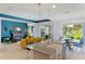 Open-concept kitchen and living area with large island, fireplace, and modern finishes at 14921 Barrows Bluff Ter, Bradenton, FL 34212