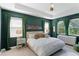Serene main bedroom with trey ceiling, three windows, and stylish decor at 14921 Barrows Bluff Ter, Bradenton, FL 34212