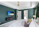 View of a modern main bedroom with en suite bathroom entrance and mounted TV at 14921 Barrows Bluff Ter, Bradenton, FL 34212
