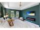 Modern main bedroom with a wall-mounted fireplace and tv at 14921 Barrows Bluff Ter, Bradenton, FL 34212