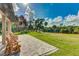 Outdoor patio featuring Adirondack chairs and views of the lush green lawn and a tranquil waterway at 14921 Barrows Bluff Ter, Bradenton, FL 34212