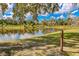 Serene pond with reflective water and lush greenery, ideal for a peaceful outdoor setting at 14921 Barrows Bluff Ter, Bradenton, FL 34212
