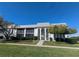 White condo building with large windows, arched entry, manicured lawn, and mature trees at 1613 Southwood St # 1613, Sarasota, FL 34231