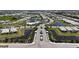 Aerial view of a Sweetwater community featuring ponds and lush landscaping, and inviting streetscapes at 16905 Sweetwater Village Dr, Bradenton, FL 34211