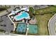 Aerial view of community amenities including a pool, pickleball and basketball courts, and a playground at 16905 Sweetwater Village Dr, Bradenton, FL 34211