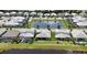 Aerial view of a neighborhood with a pond, showcasing many homes at 16905 Sweetwater Village Dr, Bradenton, FL 34211