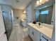 Elegant bathroom featuring double vanities, a glass-enclosed shower, and stylish fixtures at 16905 Sweetwater Village Dr, Bradenton, FL 34211