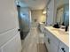 Modern bathroom featuring dual sinks, walk-in shower with pebble floor and neutral tile flooring at 16905 Sweetwater Village Dr, Bradenton, FL 34211