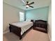 Bedroom with dark wood bed and crib, light blue walls and white carpet at 16905 Sweetwater Village Dr, Bradenton, FL 34211