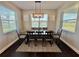 Bright dining room features a modern light fixture, large windows and space for six at 16905 Sweetwater Village Dr, Bradenton, FL 34211