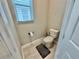 Cozy half-bathroom with neutral tones, tiled floors, and a modern toilet at 16905 Sweetwater Village Dr, Bradenton, FL 34211