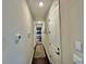 Hallway with white doors and tan walls leading to bedroom with bunk beds at 16905 Sweetwater Village Dr, Bradenton, FL 34211