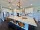 Bright kitchen with stainless steel appliances, a large island, and hardwood floors at 16905 Sweetwater Village Dr, Bradenton, FL 34211