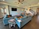 A stylish living room featuring modern furniture, a ceiling fan, recessed lighting, and luxury vinyl floors at 16905 Sweetwater Village Dr, Bradenton, FL 34211