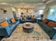 Open living area with modern decor, including sofas, rug, lighting, and connecting kitchen at 16905 Sweetwater Village Dr, Bradenton, FL 34211