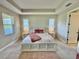 Bright main bedroom features tray ceiling, carpet flooring, and neutral decor at 16905 Sweetwater Village Dr, Bradenton, FL 34211