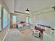 Bright main bedroom with tray ceiling, plush carpet, and furniture at 16905 Sweetwater Village Dr, Bradenton, FL 34211