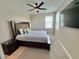 Comfortable bedroom with a king-size bed, ceiling fan, and large window for natural light at 16905 Sweetwater Village Dr, Bradenton, FL 34211