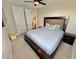 Serene bedroom with a king-size bed, neutral decor, and a mounted television at 16905 Sweetwater Village Dr, Bradenton, FL 34211