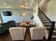 Stylish sitting area with accent wall, seating and staircase at 16905 Sweetwater Village Dr, Bradenton, FL 34211