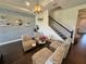 Cozy sitting area with stylish seating and a staircase at 16905 Sweetwater Village Dr, Bradenton, FL 34211