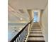 A staircase features dark wood steps and railing against a light neutral wall and ceiling at 16905 Sweetwater Village Dr, Bradenton, FL 34211
