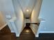 View of a staircase with hardwood steps and a dark railing in a well-lit home at 16905 Sweetwater Village Dr, Bradenton, FL 34211