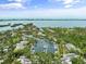 Stunning aerial view showcasing waterfront homes and a private boat marina at 1703 Pelican Cove Rd # 356, Sarasota, FL 34231
