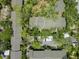 Aerial view of the property with surrounding trees and other homes at 1703 Pelican Cove Rd # 356, Sarasota, FL 34231