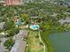 Community aerial view with pool, lush landscaping, boardwalks and bay views at 1703 Pelican Cove Rd # 356, Sarasota, FL 34231