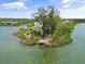 Waterfront community with lush trees and bay views from a high angle aerial view at 1703 Pelican Cove Rd # 356, Sarasota, FL 34231
