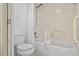 This bathroom features a tiled shower and safety bars at 1703 Pelican Cove Rd # 356, Sarasota, FL 34231