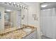 Bathroom featuring a granite countertop, a sink, framed mirror, lighting, and shower with shower curtain at 1703 Pelican Cove Rd # 356, Sarasota, FL 34231