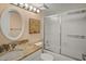 Updated bathroom with granite countertop, oval mirror and glass shower doors at 1703 Pelican Cove Rd # 356, Sarasota, FL 34231