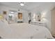 Inviting bedroom featuring a queen bed, white furniture, complemented by a ceiling fan and natural lighting at 1703 Pelican Cove Rd # 356, Sarasota, FL 34231