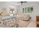 Inviting bedroom with twin beds, shuttered windows, and neutral decor at 1703 Pelican Cove Rd # 356, Sarasota, FL 34231