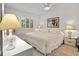 Comfortable bedroom with a queen bed, white furniture, a ceiling fan, and plantation shutters for natural light at 1703 Pelican Cove Rd # 356, Sarasota, FL 34231
