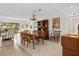 Dining room with a wood table, chairs, and hutch, complemented by tile floors and natural lighting at 1703 Pelican Cove Rd # 356, Sarasota, FL 34231