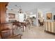 Bright, open living and dining area with tile floors, a large dining table and pass through to kitchen at 1703 Pelican Cove Rd # 356, Sarasota, FL 34231