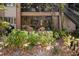 Outdoor patio with two chairs and view of well maintained landscaping at 1703 Pelican Cove Rd # 356, Sarasota, FL 34231
