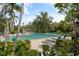 Community pool with lounge chairs and lush landscaping, ideal for relaxation and entertainment at 1703 Pelican Cove Rd # 356, Sarasota, FL 34231