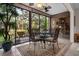 Bright sunroom with tile floor, ceiling fan and an outdoor view at 1703 Pelican Cove Rd # 356, Sarasota, FL 34231
