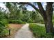 Scenic walking path winding through lush greenery, offering a peaceful outdoor experience at 1703 Pelican Cove Rd # 356, Sarasota, FL 34231