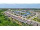 Expansive aerial view of a neighborhood featuring a large pond, manicured lawns, and many single Gathering homes at 17032 Harvest Moon Way, Bradenton, FL 34211