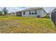 Exterior shot of backyard with grass lawn, fence, screened in patio, and home at 17032 Harvest Moon Way, Bradenton, FL 34211
